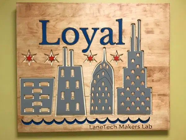 A plaque with the word Loyal above a carved Chicago skyline and the four red stars of the city flag.