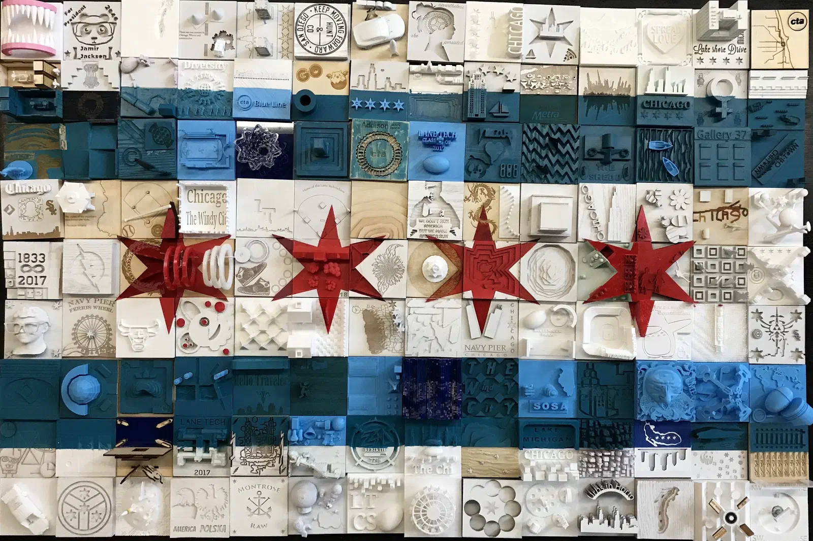 A Chicago flag assembled from dozens of small carved and painted wooden tiles, each made by a different student.