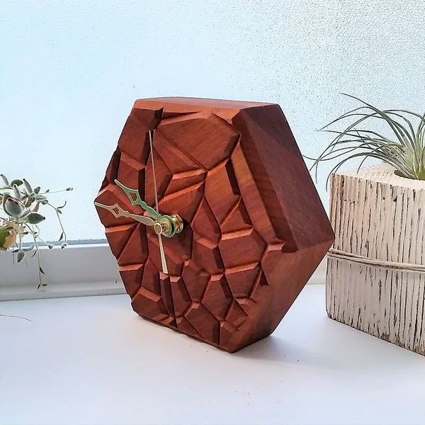 A faceted red wooden clock with an irregular cell pattern across its face.
