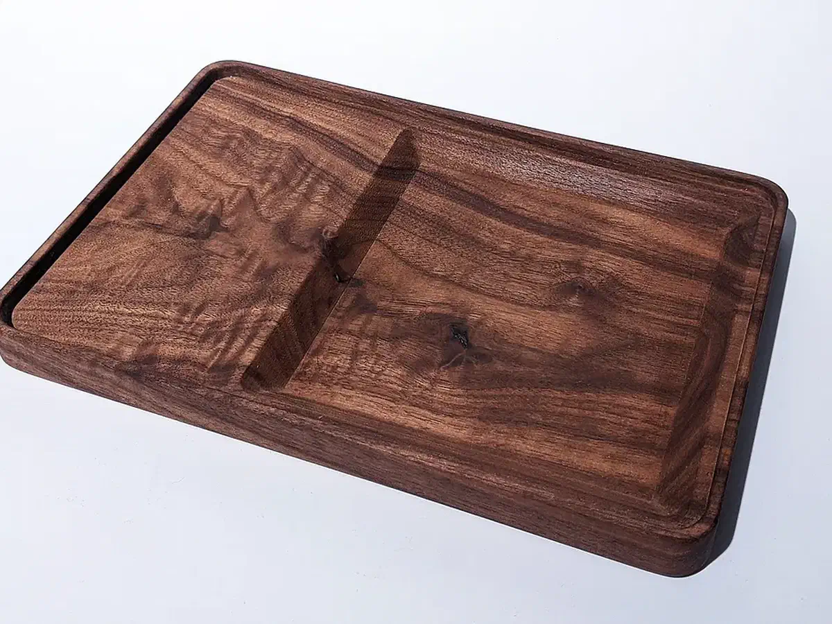 Finished empty walnut tray with a broad recessed basin and a raised rectangular section