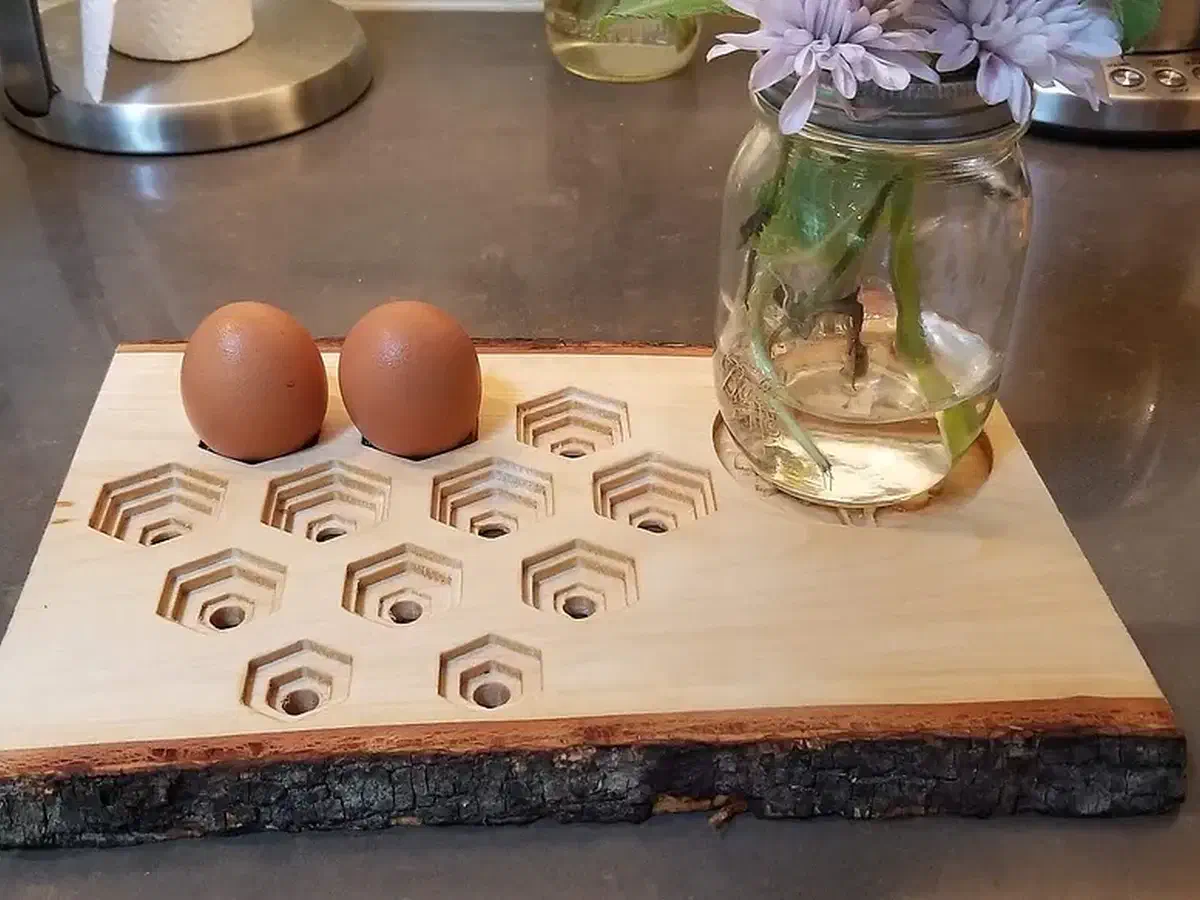 Eggs standing in a carved live-edge wooden tray