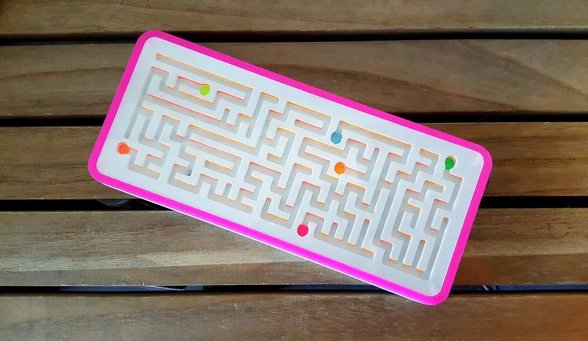 A finished long white maze with a clear cover and pink border