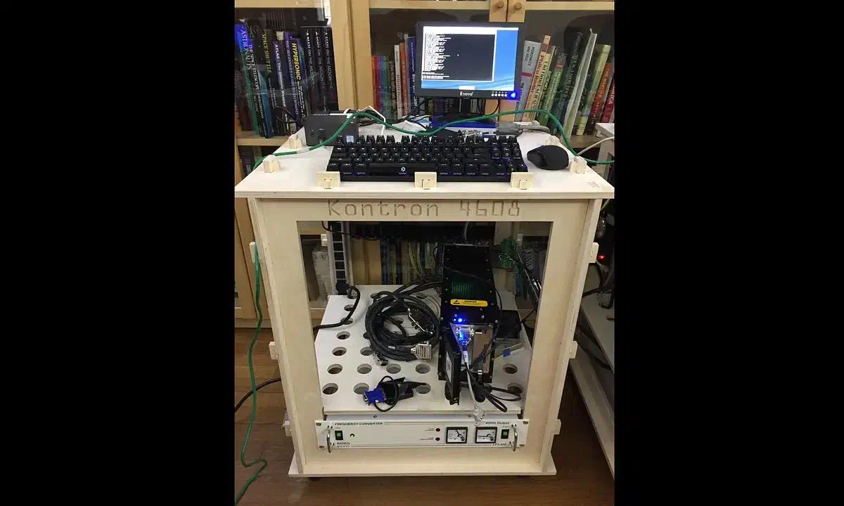 A completed open wooden equipment rack holding audio gear and a keyboard