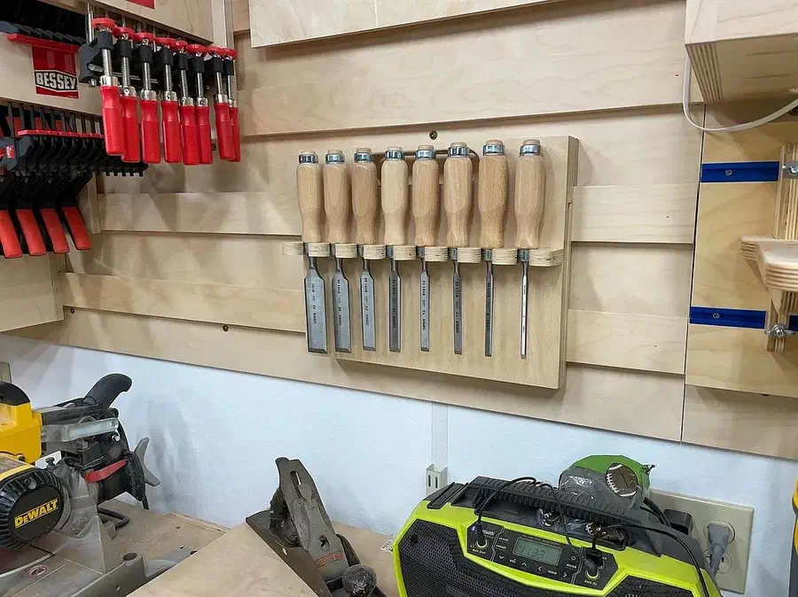 Steve Moseley’s plywood chisel rack mounted on a workshop wall holding a row of chisels