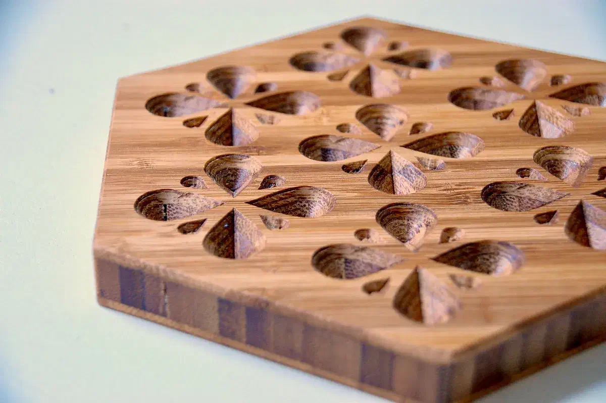 Bamboo trivet with carved teardrop clusters