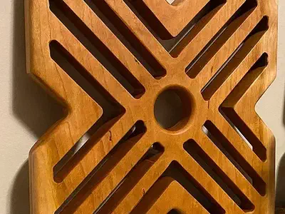 Close view of Brett’s large bamboo trivet with diagonal slots and notched edges