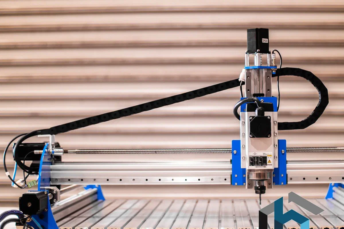 A BlueCarve Turbo CNC router with a blue gantry on a slatted bed.